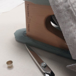 Thumbnail double sleeve board on desk with shears, thimble & pad stitched collar