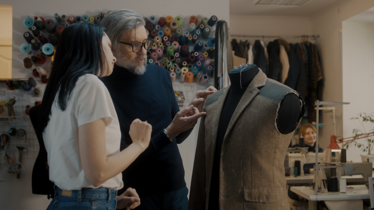 Fashion Designer Shows Sketch To Seamstress Fashion Designer Shows Sketch To Seamstress